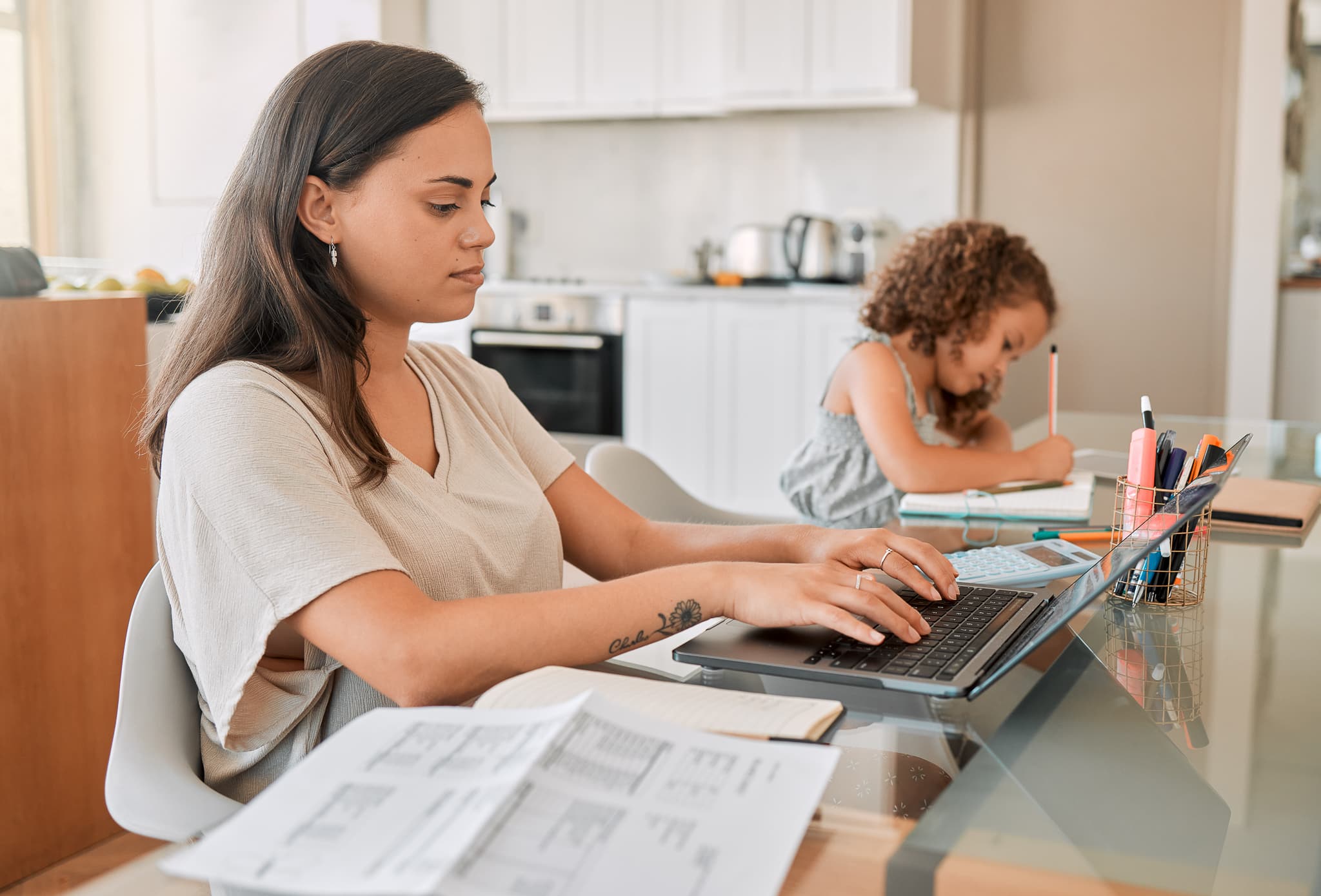 Mom working from home with distance learning child, multitasking