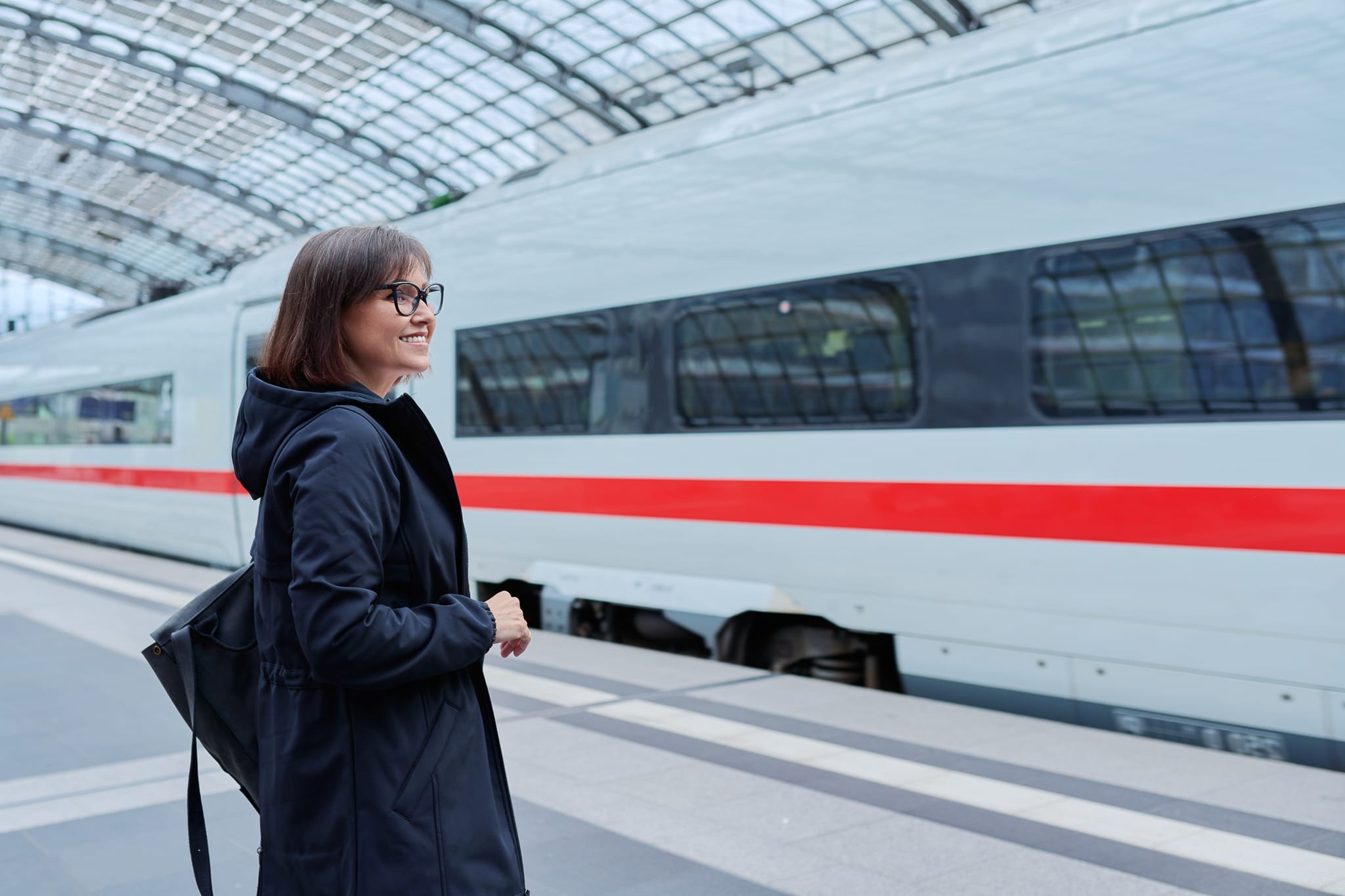 Woman passenger on railway platform inside station